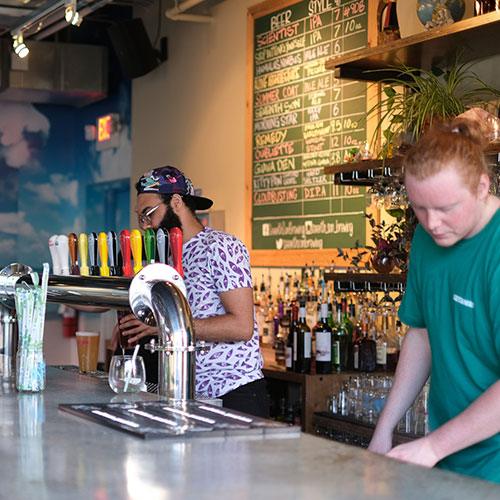 brewery workers behind bar