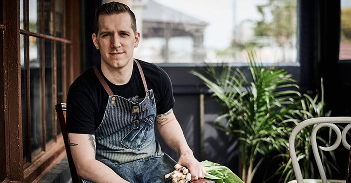 chef holding fresh scallions