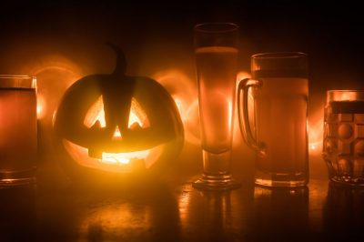 halloween carved pumpkin and craft beer spooky scene