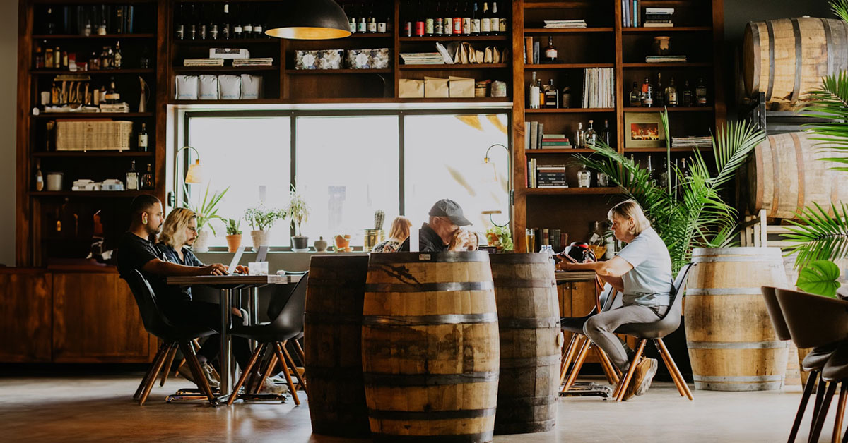 moody brewery and coffee shop interior with patrons working