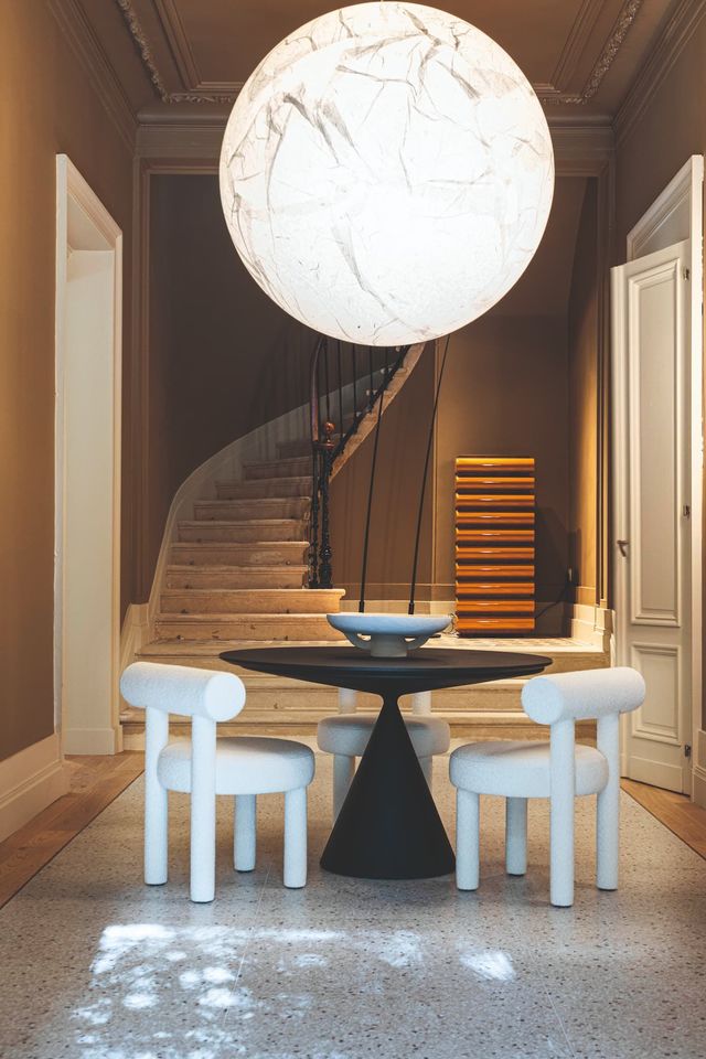 Dans l'entrée, chaises "Gropius CS1", design Kateryna Sokolova, Noom Home ; table "Clay", Marc Krusin, Desalto ; suspension "Moon", Davide Groppi ; meuble 8 tiroirs "Storet", Nanda Vigo, Davide Groppi, Acerbis.